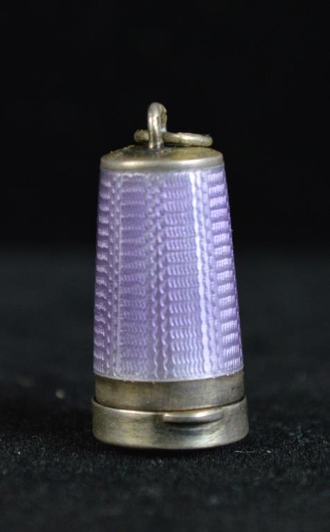 STERLING GUILLOCHE ENAMEL CIGARETTE TIP CASE: Locket or charm. Light purple guilloche enamel. Marked 925 on loop. Inside is collapsible sterling and bone cigarette tip. Gold vermeil inside. Dimension: Case: 7/8" Cigarette Tip open: 3" Condition: 