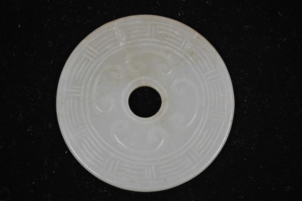 QING DYNASTY CARVED JADE BI-DISC PLAQUE 5: With C-like curled carvings Dimensions: Diameter 2 3/8" x W 1/8" Condition: very good, no apparent issues Provenance: From the Estate Antique collection of Arthur + Joe Robinson