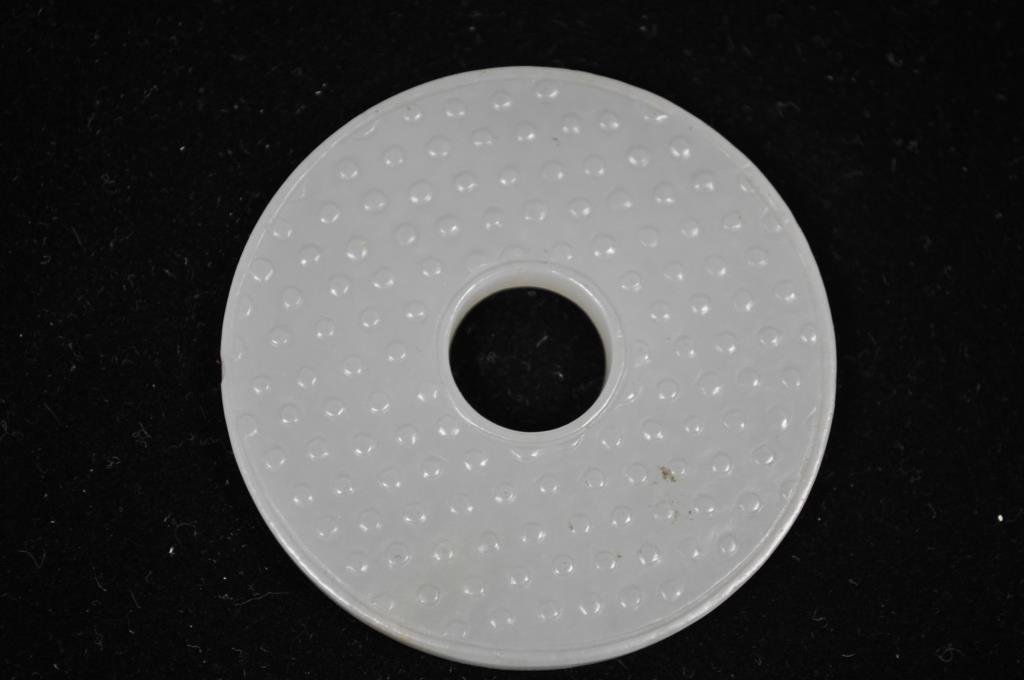QING DYNASTY CARVED JADE BI-DISC PLAQUE 7: With dimpling to both sides Dimensions: Diameter 2 5/16" x W 1/4" Condition: chip to rim, light wear to edges Provenance: From the Estate Antique collection of Arthur + Joe Robinson