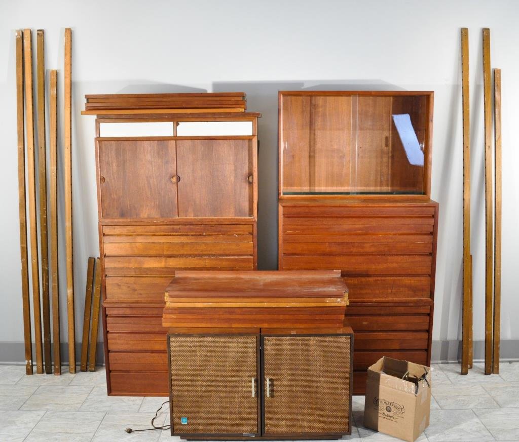 POUL CADOVIUS ROYAL SYSTEM SHELVING UNIT: With a General Electric Stereophonic radio, record player, and speakers, 4 4-drawer cabinets, 14 shelves, a glass display cabinet, a 2 drawer shelf, a sliding door cabinet, hardware, 10 large wall rai