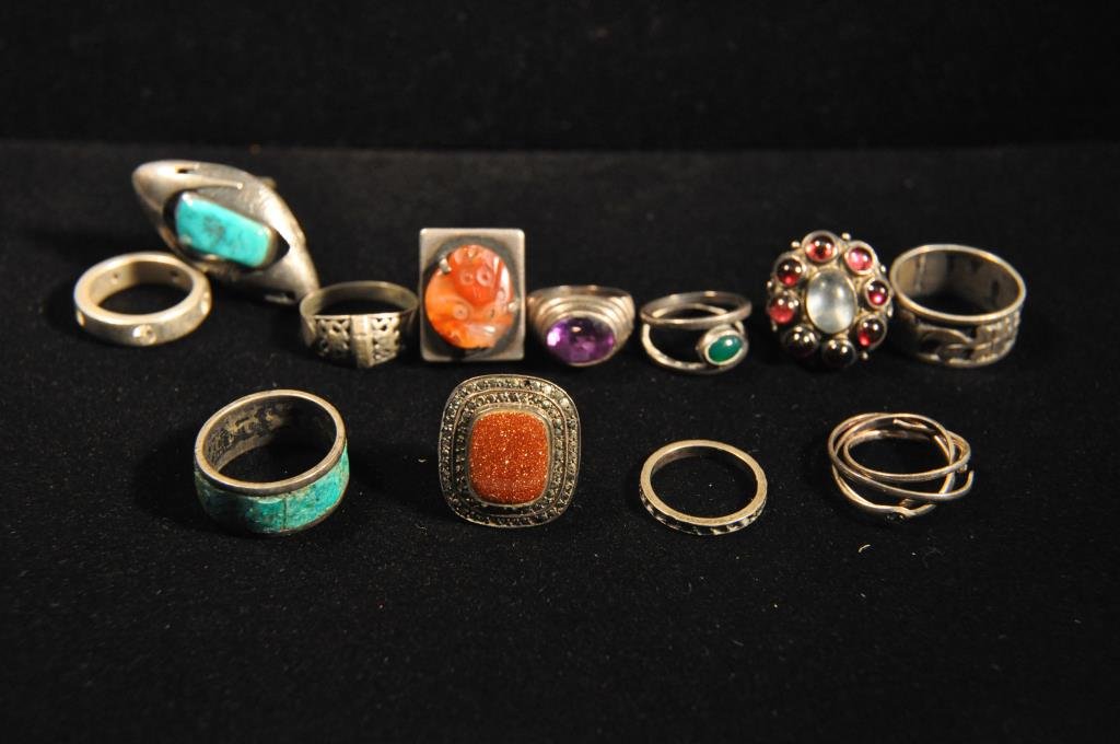 GROUPING OF 12 STERLING SILVER RINGS: Including marcasite, goldstone, turquoise and quartz. Total Weight: 49.7 dwt Condition: Good.