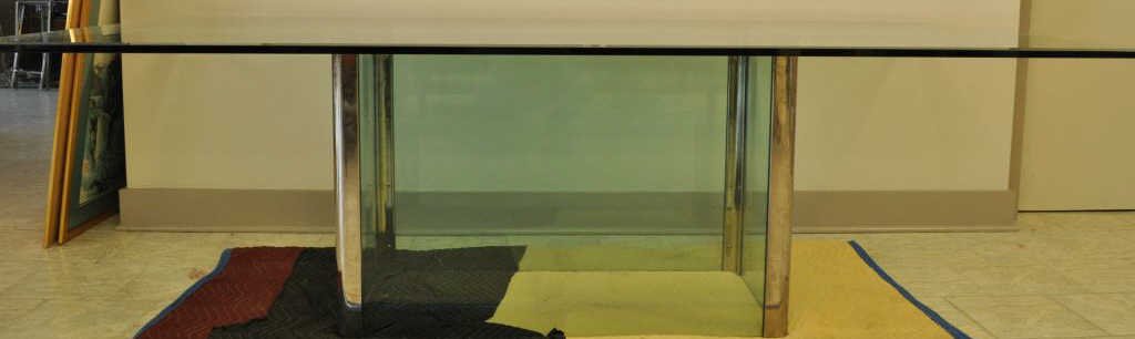 LEON ROSEN PACE COLLECTION GLASS DINING TABLE: Leon Rosen, ca. 1970. Consignor had brass fittings chromed. Dimensions: L 78" x W 40" x H 29" Condition: two chips to glass on bottom of base