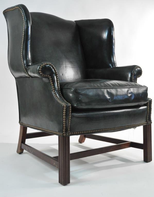 MID-CENTURY LEATHER WINGBACK LOUNGE CHAIR: Dimension: H 31" X W 32" X D 30" Condition: some white paint? speckles to leather, 4 small chips to leather finish layer on wing, light wear to base. Overall the chair has a great appearance.