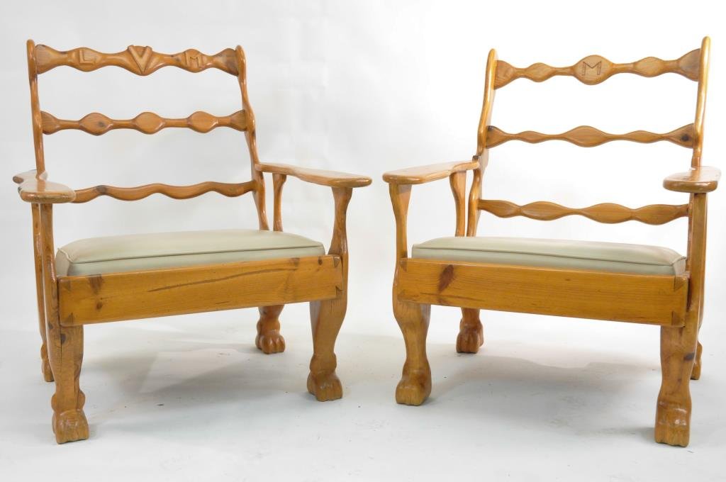 PAIR OF STUDIO CARVED HIS AND HER ARMCHAIRS: Of solid wood and organic form, one carved "M" to top rail, the other carved LVM to top rail. Dimensions: H 34" x W 27 1/2" x D 32" Condition: both good, some marks to vinyl