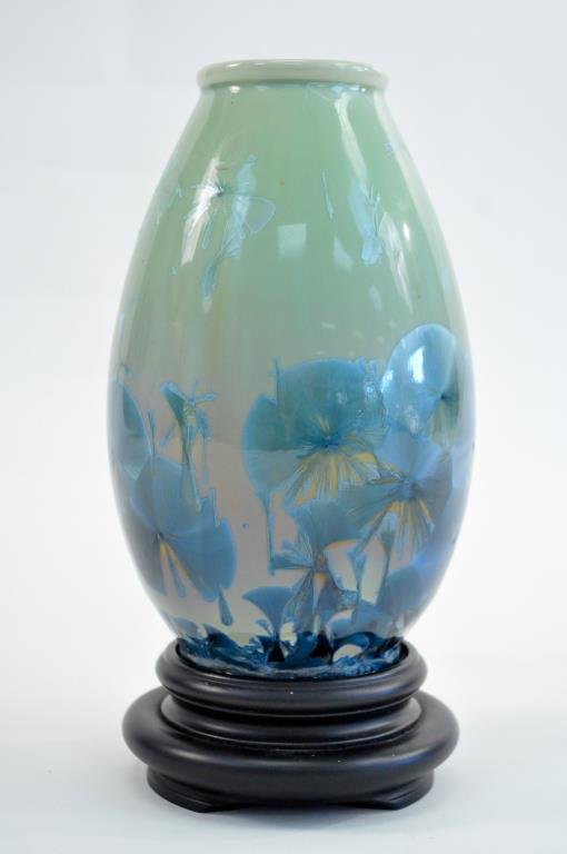 CRYSTALLINE GLAZE CERAMIC VASE: Signed on bottom with 3 star symbol as well as two other markings. Dimensions: H 12" on stand ( 10" w/o stand ) X Diameter 6" Condition: Good