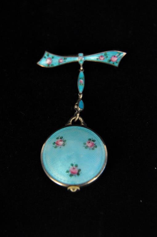 ANTIQUE STERLING AND GUILLIOCHE ENAMEL WATCH PIN: Bucherer 17J watch, running. Dimension: L 2 1/2" X W 1" Condition: Very good.