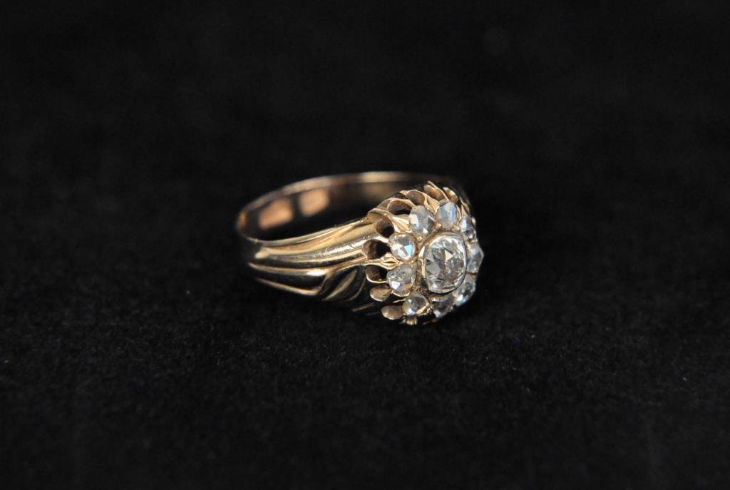 ANTIQUE RUSSIAN CUSHION CUT .30 POINT DIAMOND RING: 14K Rose gold. 1 center .30pt diamond with 9 smaller diamonds around. Ring Size: 7 1/2 Total Weight: 3.2dwt Condition: Good