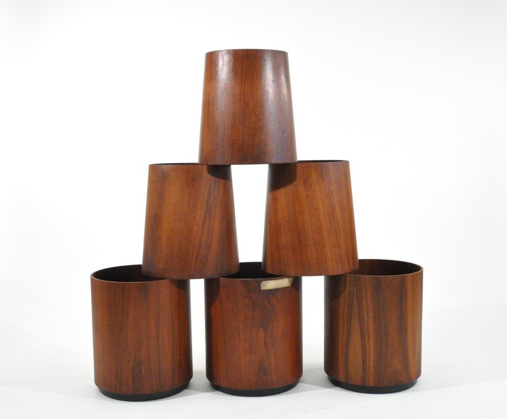 GROUPING OF 6 JENS RISOM WASTEBASKETS: 3 Cylindrical and 3 Tapered, with labels to bottom, one from the corporate offices in CTDimensions: H 14.25" x Diameter 12" cylindricalDimensions: H 13.5" x Diameter 12" taperedCondition: good, some w