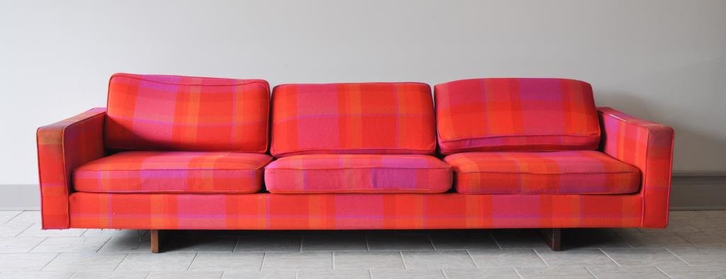 MID-CENTURY JENS RISOM SOFA: With manufacturers label, wooden plank feet, and a bright, plaid mid-century fabricDimensions: H 22.5" x W 108" x D 36.5"Condition: tears to fabric on back corners, piping undone on one armrest, fadin