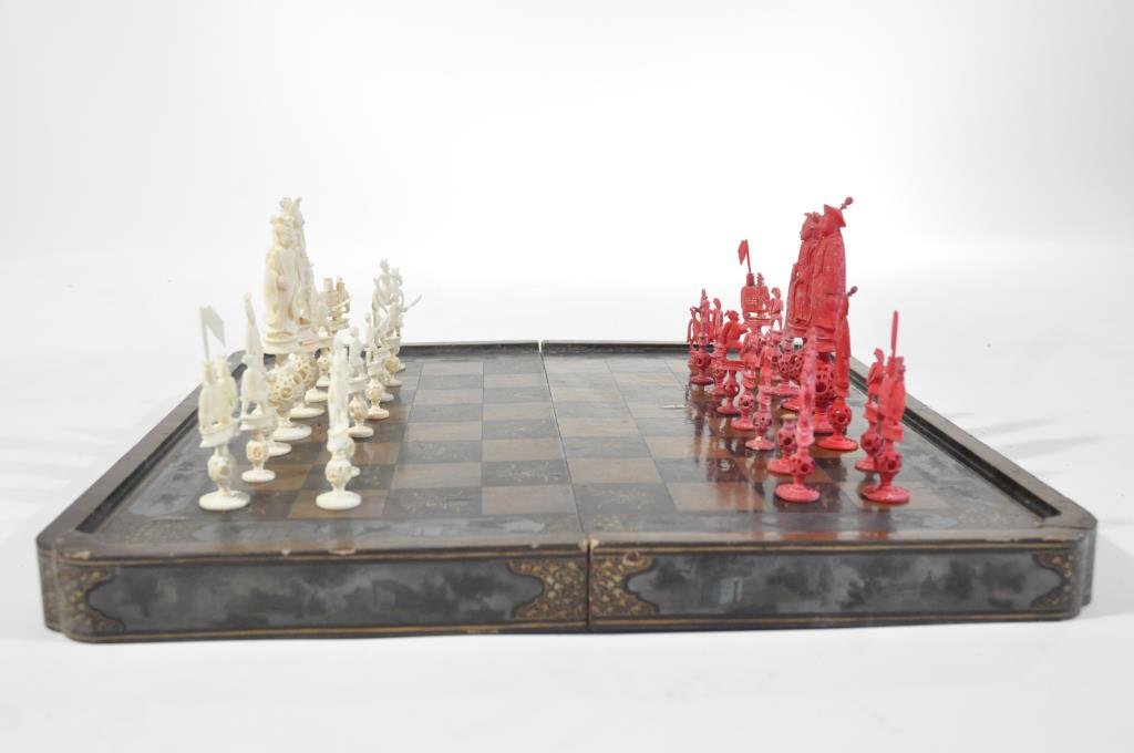 CHINESE CANTON CARVED IVORY CHESS SET: Circa 19th century, including a lacquered game boardDimensions: H 2" x W 19.5" x D 19.5" boardDimensions: H 6.5" x W 1.5" x D 1" kingDimensions: H 2.5" x W .75" x D .5" pawnCondition: missing one whit