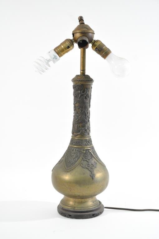 CHINESE BRONZE VASE LAMP W DRAGONS: Dimension: H 24" (tp top of finial) X D 7"Condition: Drilled to convert into lamp. Dent on side, damage to wooden base in one area. Provenance: From the descendants of a late 19th C. Siam logging oper