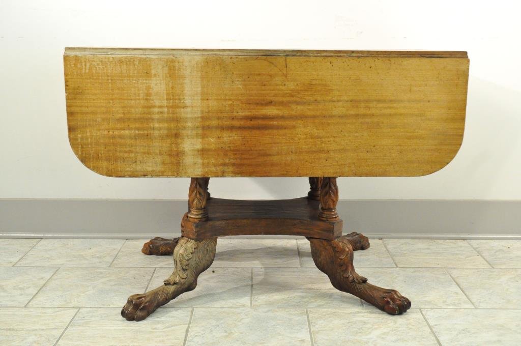 19TH C. DROP LEAF TABLE W/ CARVED FEET: Dimensions: H 26.75" X W 43.75" X D 38" OPENCondition: Signs of use and sun fading.
