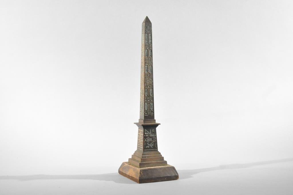FRENCH BRONZE MODEL OF THE LUXOR OBELISK: Circa 19th century, bronze Replica of the Luxor Obelisk from the Place de la Concorde, France, on wood baseDimensions: H 14.5" x W 5" x D 4"Condition: good, wear to wood base, missing back plate
