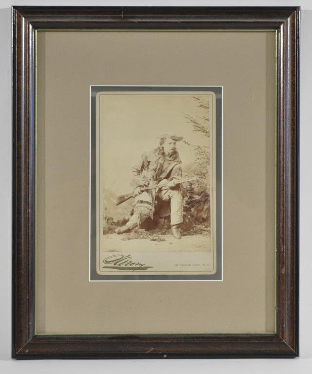 SIGNED BUFFALO BILL CABINET CARD PHOTOGRAPH: William F. CODY (a.k.a. "Buffalo Bill). A cabinet card photograph by Sarony, New York showing a seated Cody holding a rifle, signed and inscribed by Cody on the reverse: "W. F. Cody 'Buffalo Bill' 189
