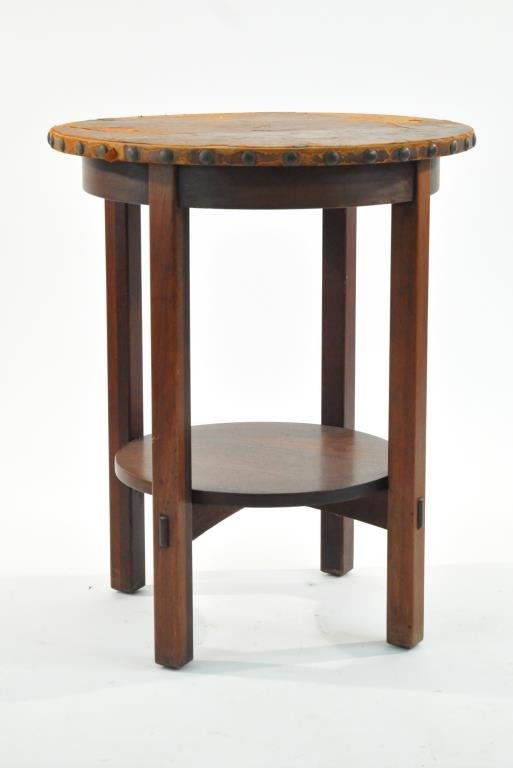 L. & J.G. STICKLEY LEATHER TOP TABLE: With original leather, unmarkedDimensions: H 29.5" x Diameter 25"Condition: good overall appearance, losses and splitting to leather covering, almost completely disconnected from topProvenance: From t