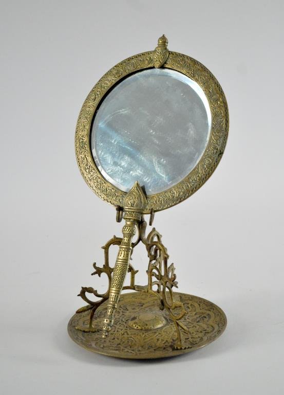 TIFFANY & CO BRONZE MOORISH DRESSER MIRROR & STAND: Unsigned. Dimensions: H 7.5" X D 7.25"Dimensions: H 13.75" X D 7.25"Condition: Good, original beveled mirror, usual signs of age.