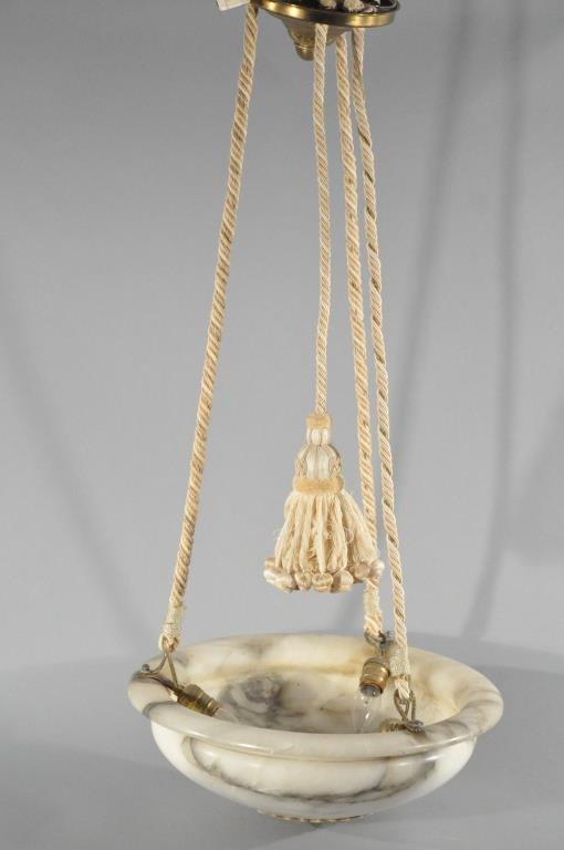 HANGING MARBLE LIGHT FIXTURE: Marble shade suspended from a rope, brass ceiling plate included. Dimensions: H 38.5" x Diameter 18"Condition: Good.