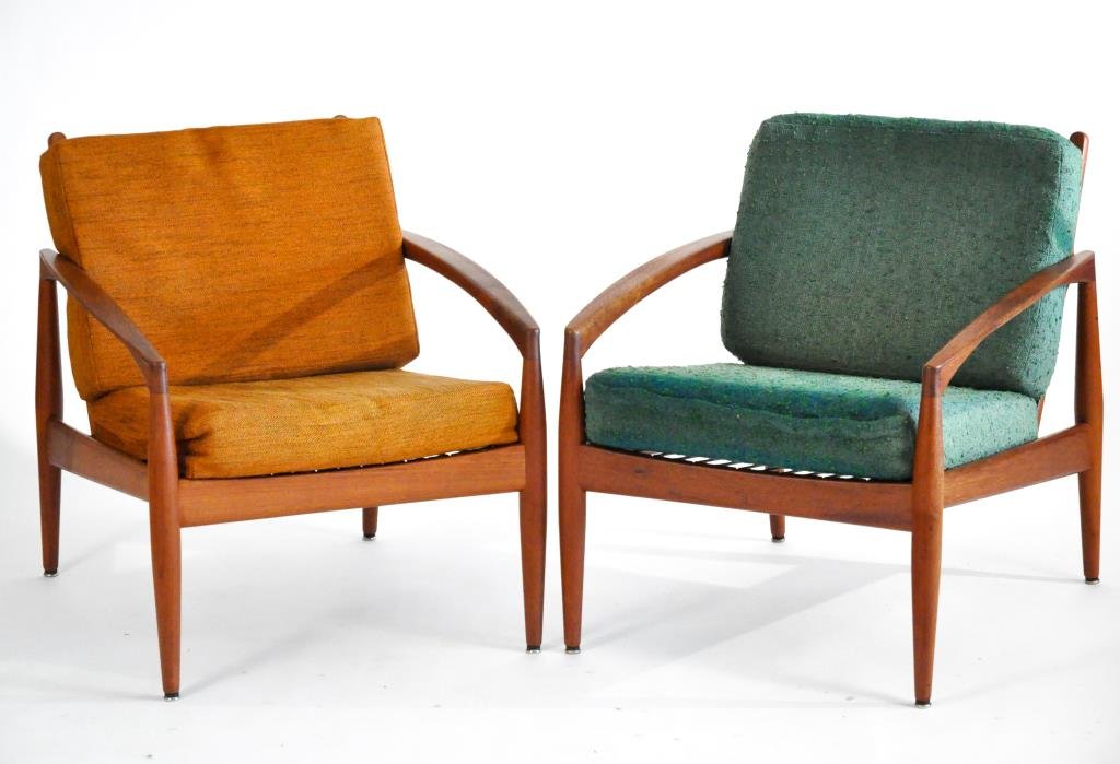 PAIR OF KAI KRISTIANSEN DANISH #121 LOUNGE CHAIRS: Designed in 1955, Teak, Model 121 for Magnus Olesen, each marked to front stretcherDimensions: H 29" x W 25" x D 28"Condition: very good, some light wear from use, cushions show sun staining