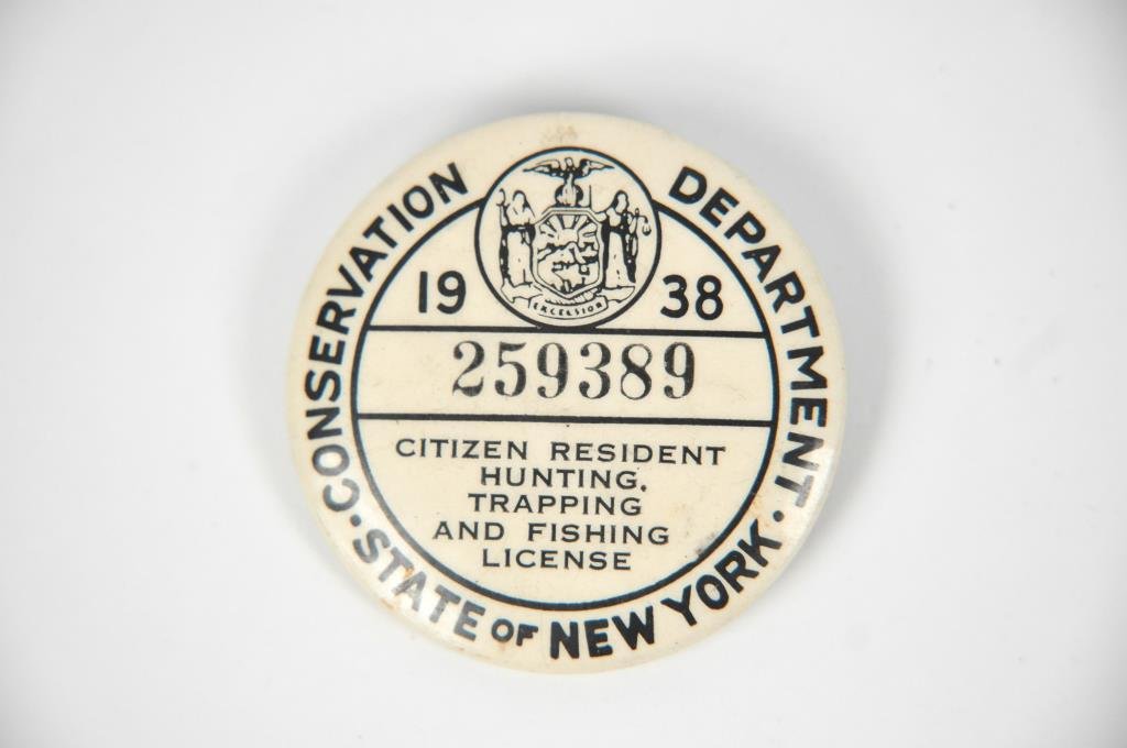1938 NY STATE RESIDENT HUNTING & FISHING LICENSE: State of New York Conservation Department. 1938. 259389. Citizen resident hunting, trapping, and fishing license. Dimensions: dia 1.75"Condition: some discoloration to button, some rust to back