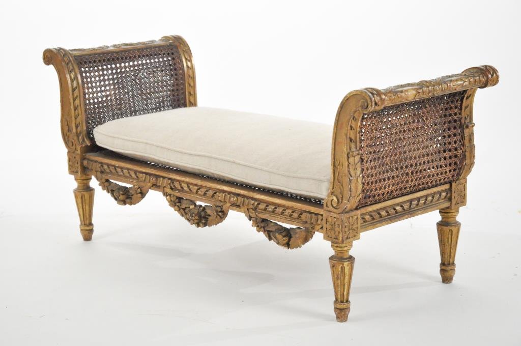 19TH C. FRENCH GILT WOOD MINI DAYBED DOG BENCH: Caning and swag detail, reupholstered pillow Dimensions: H 16" x W 37.5" x D 14" Condition: Good, small chips