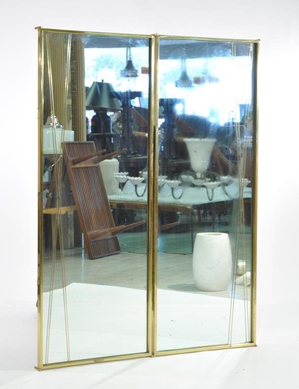 PAUL MCCOBB PAIR OF X STYLE PIER MIRRORS: Circa 1950s, for Calvin, brass and mirror, metal manufacturers labelDimensions: H 54" x W 21" x D 2.25" eachCondition: Warm patina to brass. Original mirror. No breaks or repairs. Very good overall co