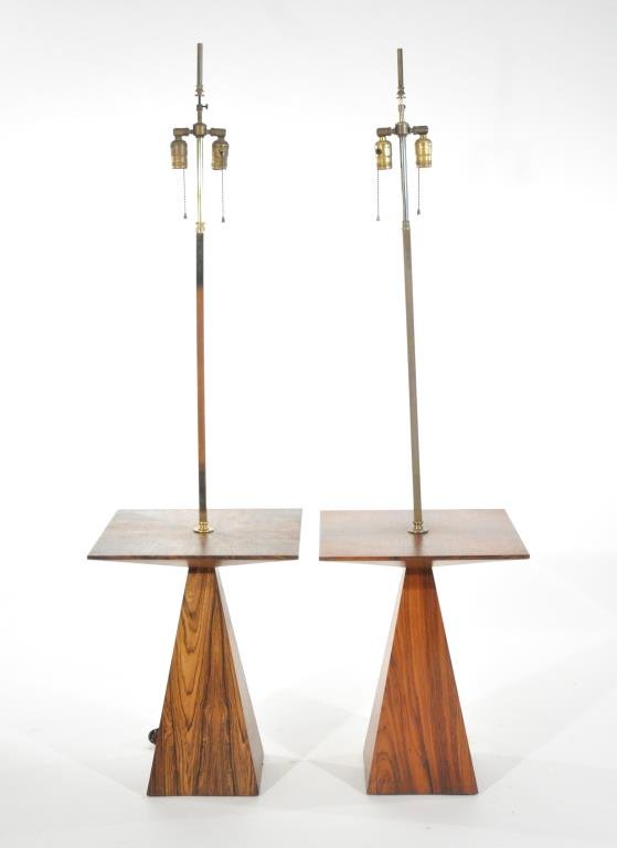HARVEY PROBBER, PAIR OF LAMP TABLES: Circa 1960s, for Harvey Probber Inc, one of rosewood and brass, the other of walnut and brassDimensions: H 59.25" (to finial) x W 16" x D 16"Condition: Lights scuffs to wood. Minor oxidation to brass.