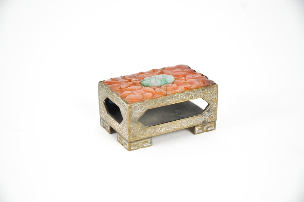 CHINESE CARVED JADE & CARNELIAN MATCHBOX: Brass, carved jade and carnelian. Marked CHINA under.Dimensions: H 1" X W 2.5" X D 1.75"Condition: crack to carnelian, signs of use