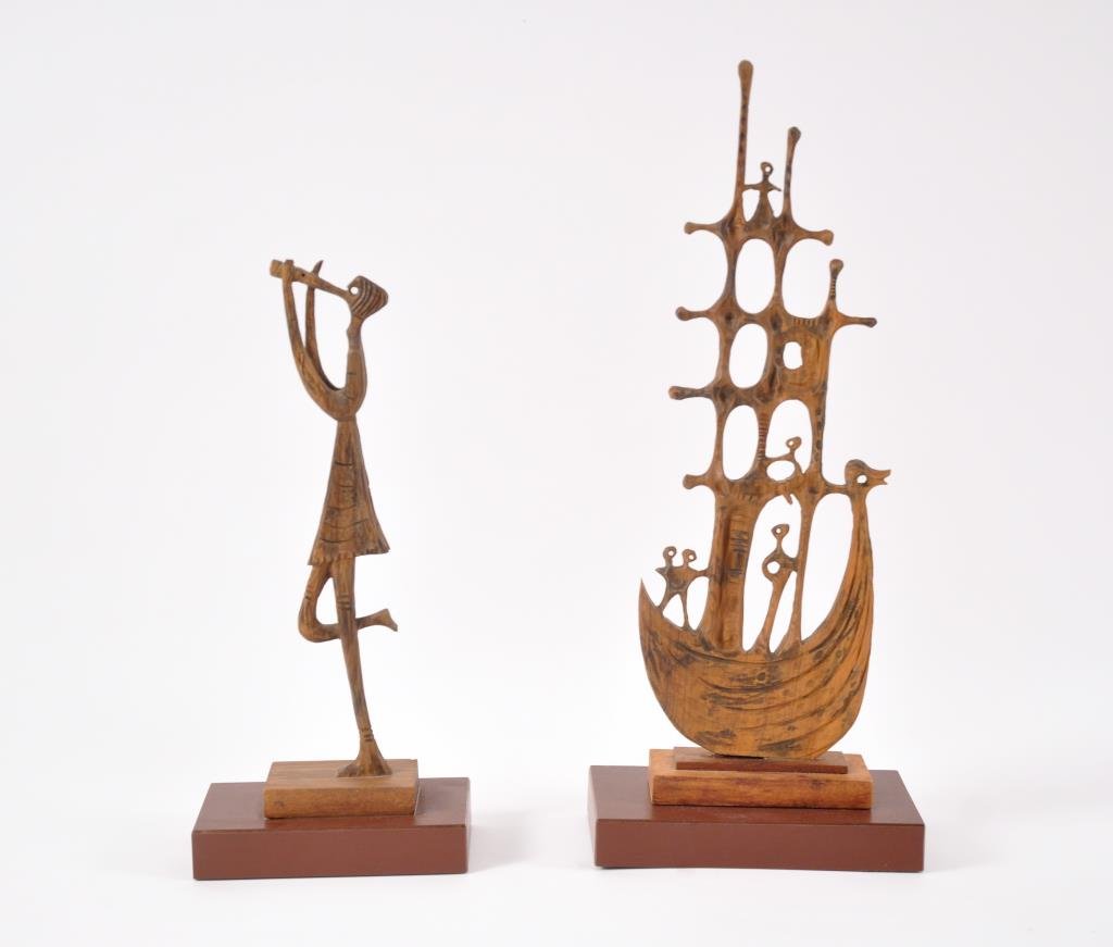(2) A. BEZALEL WOODEN SCULPTURES: Signed underneath one as shown in the photos the other is still attached to the base.Dimensions: H 15" x W 6" x D 3.5" (base, larger)Condition: good, boat is detached from base