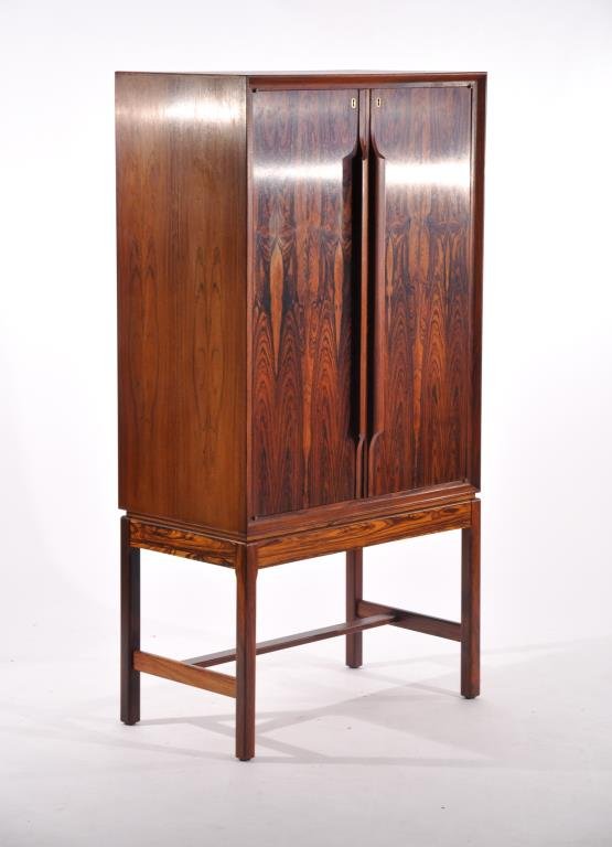 TORBJORN AFDAL (ATTR.) ILLUMINATED BAR CABINET: For Bruksbo, Finland, circa 1970s, rosewood and finished interior, manufacturers label underneath cabinetDimensions: H 57.5" x W 29.5" x D 16.5"Condition: Over coat to original finish on top. Very goo