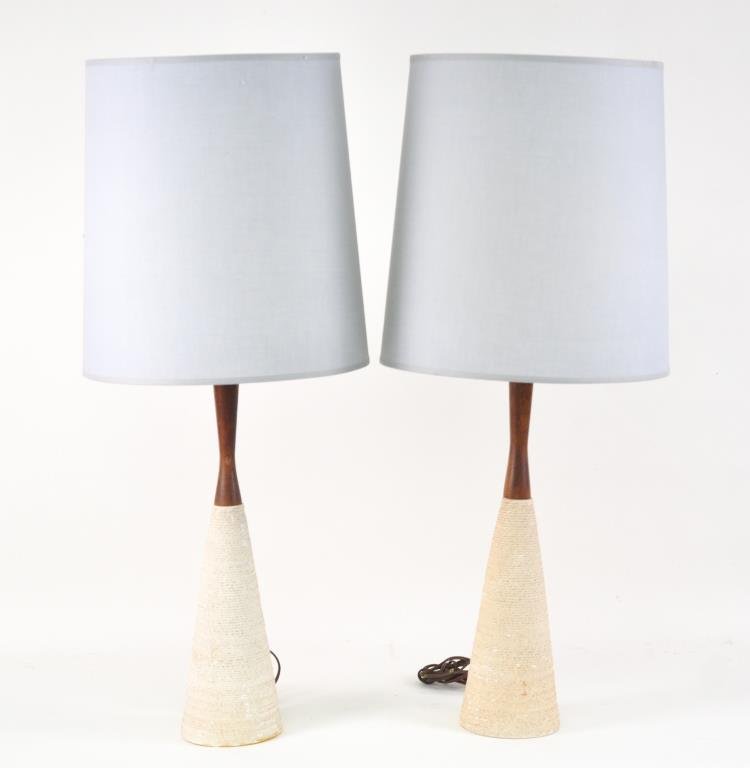 PAIR OF MID-CENTURY TEAK & CERAMIC TABLE LAMPS: Rope patterned ceramic. Signed at bottom, 1957 and an illegible maker. With blue shades.Dimensions: Lamps: H 29.5" X D 5" Shades: H 14" X D 15"Condition: Good, small chips to ceramic. Shade has slight