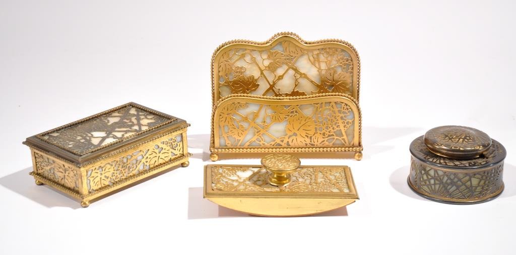 TIFFANY STUDIOS GRAPE LEAF PATTERN BRONZE DESK SET: 4 pieces including a letter holder, inkwell, box, and and a rocker blotter. All marked. Dimensions: H 5.5" x W 6.5" x D 2.5" letter holder Condition: quite good, some cracks to glass