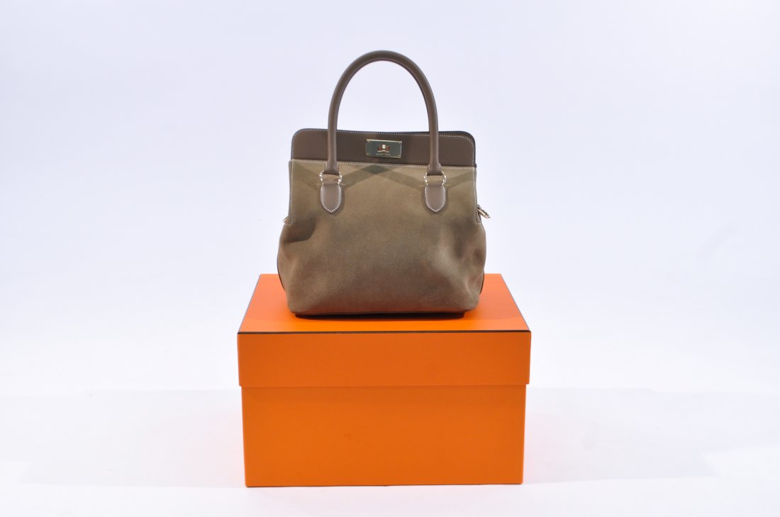 HERMES TOOLBOX BAG MODEL 26: New, never used. Suede and stitched leather. Still contains protective plastic coating over brass accents, dust bag, leather protective covers, and rain cover. Also included is the lock and two keys, 