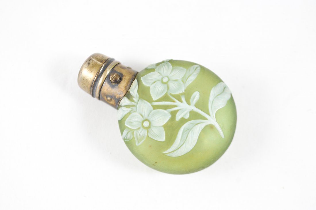 WEBB GREEN CAMEO GLASS SCENT PERFUME BOTTLE: Attributed to Thomas Webb & Sons but unsigned with hinged English sterling silver cap, C. 19th Century. White to green cut cameo glass decorated with flowers and foliage. Dimension: H 3" x W 2" Condit