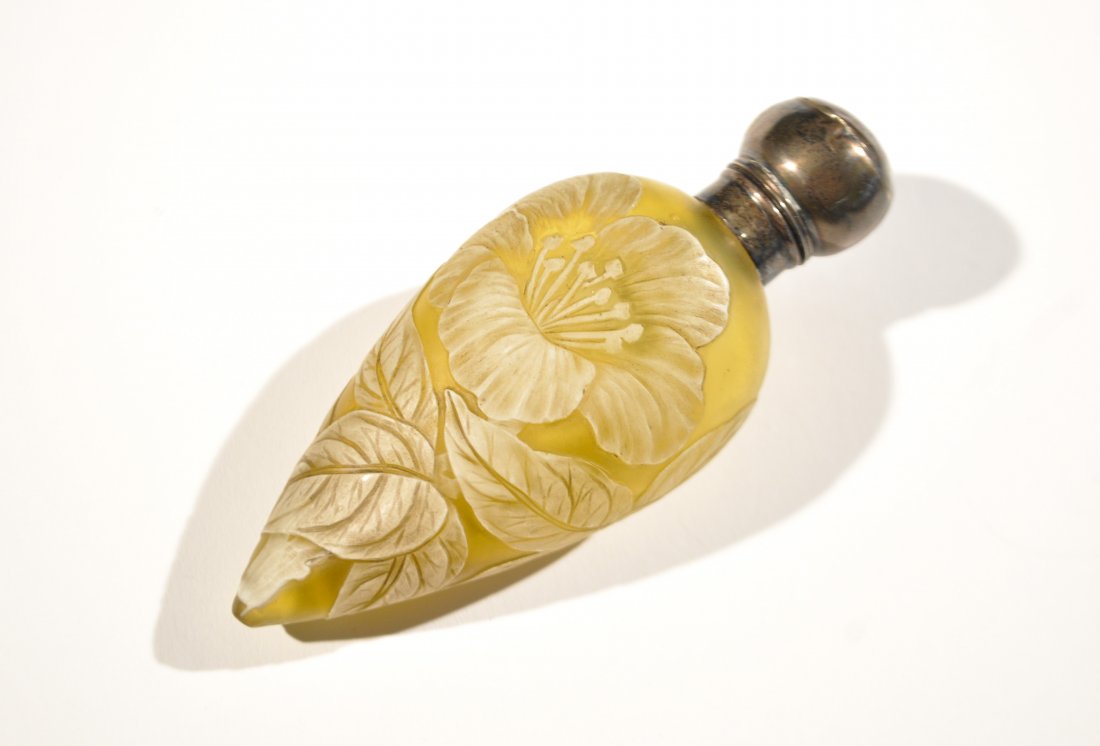 WEBB CAMEO GLASS SCENT PERFUME BOTTLE: White to yellow cut cameo glass with hibiscus flower and foliage, sterling silver cap. Unsigned but attributed to Thomas Webb & Sons. Dimensions: L 4.25" x W 1.75"Condition: Good, normal signs to age.