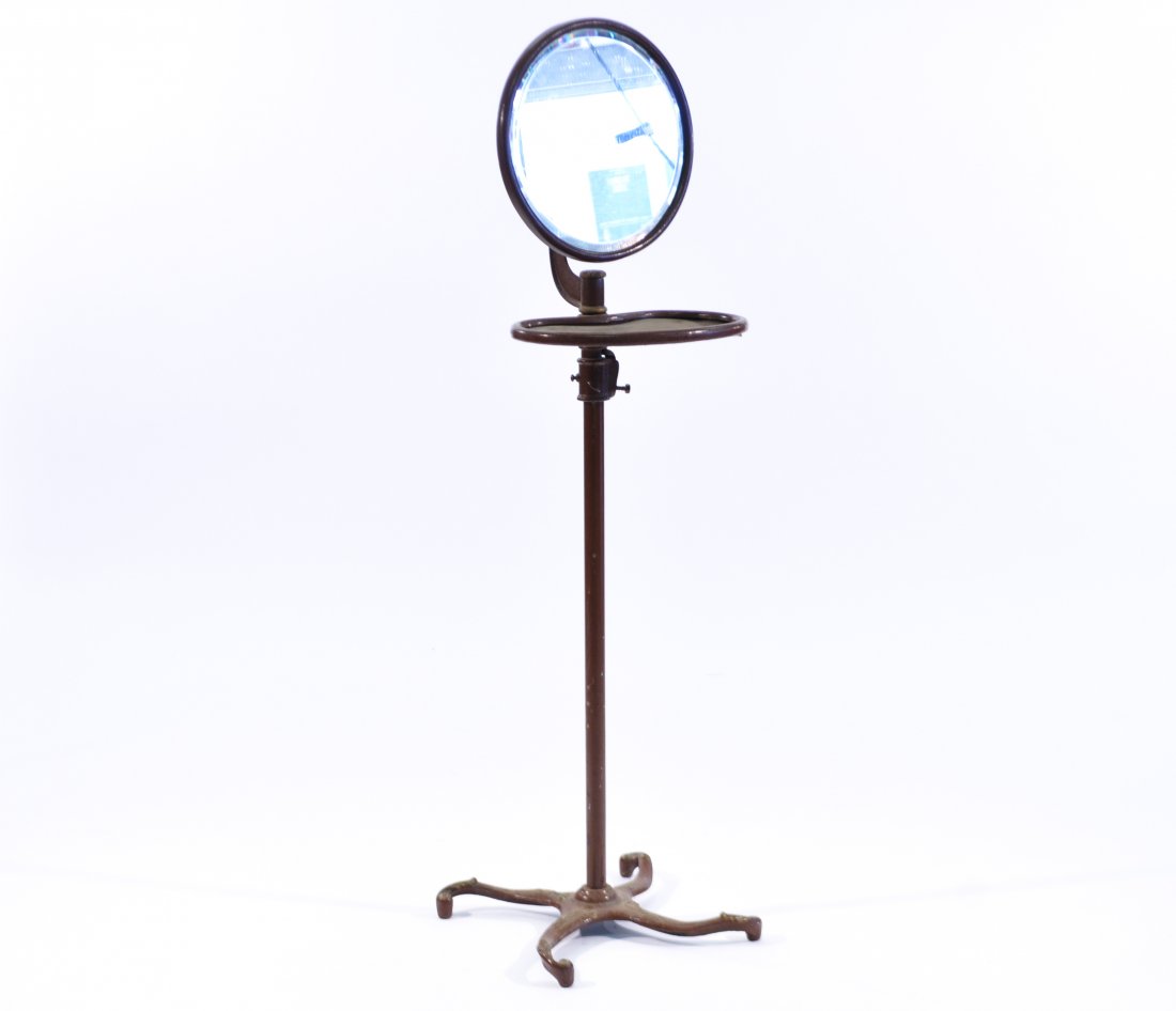 ANTIQUE IRON SHAVING MIRROR AND STAND: Beveled glass mirror on an adjustable, paint decorated frameDimensions: H 47" x D 18.5"Condition: good, some small losses to paint