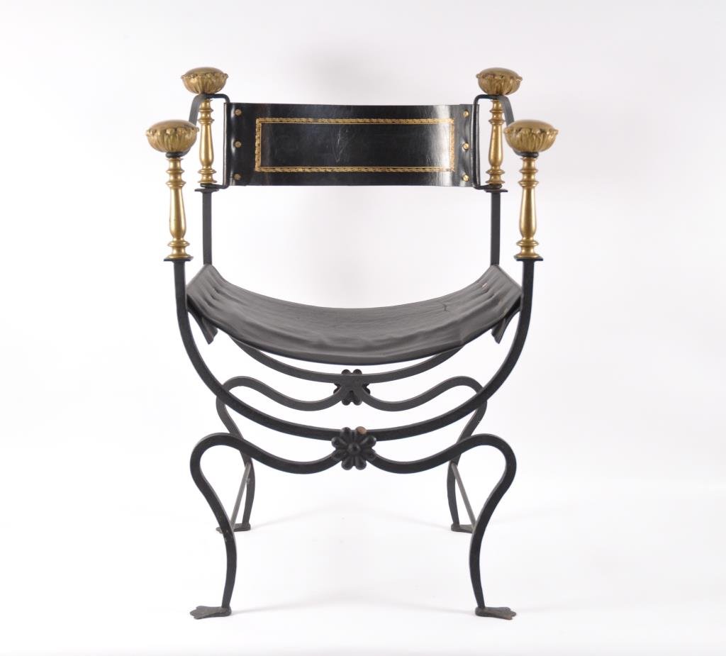 ITALIAN LEATHER 'SAVONAROLA HALL CHAIR': Hammered wrought iron frame with bronze fittings and finials, leather seating and back rest. Italian, circa 1900. Dimensions: H 33" x W 24" x D 17" Condition: good, some scratching to bronze