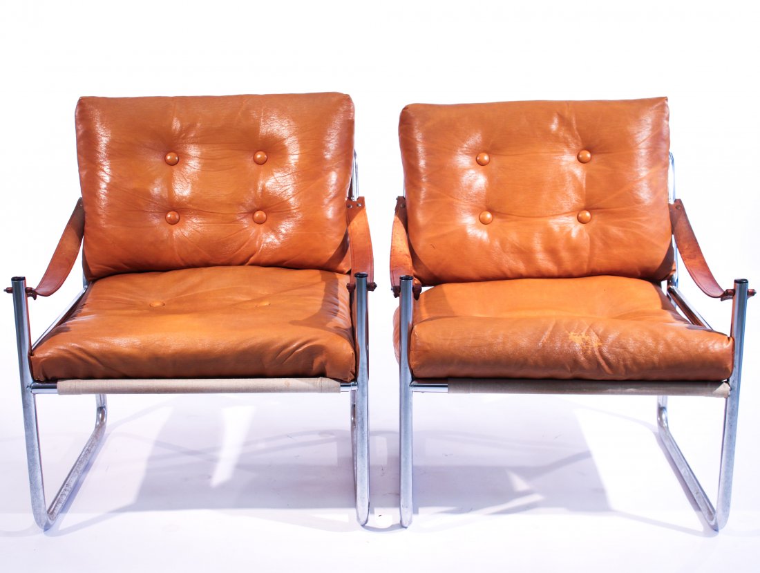 MODERN TUBULAR CHROME SLING ARM LOUNGE CHAIRS: Canvas backed, unmarkedDimensions: H 30" x W 29" x D 26"Condition: good, wear to leather on front of seat