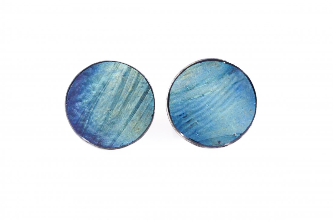 PAIR OF EDWARD WORMLEY TIFFANY GLASS CUFFLINKS: From the estate of Edward Wormley, made for himself during the period he was designing Tiffany Favrille tile tables. Glass tiles on sterling silver cuffs. Dimensions: D 1"Condition: Good(Silver box, a