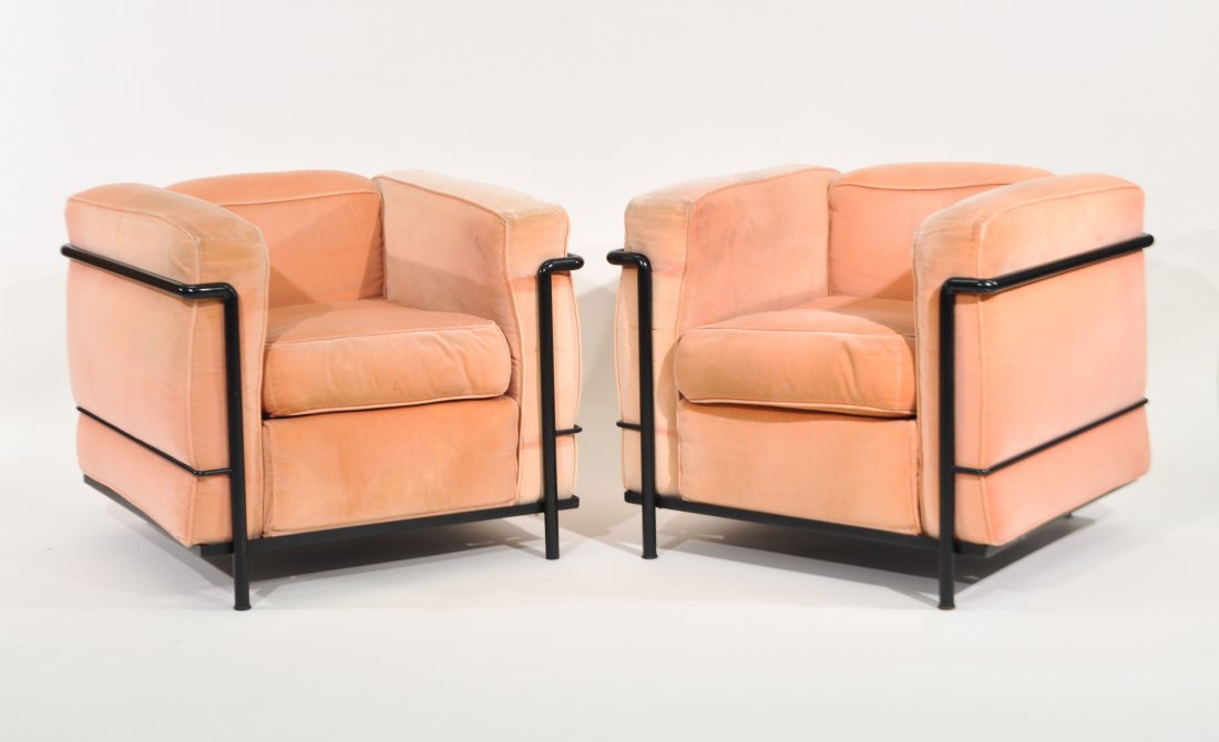 PAIR OF LE CORBUSIER LC2 LOUNGE CHAIRS FOR CASSINA: With black tubular frames. Cassina label under.Dimensions: H 26" x W 29" x D 27"Condition: Some minor scratching, staining and fading to upholstery.