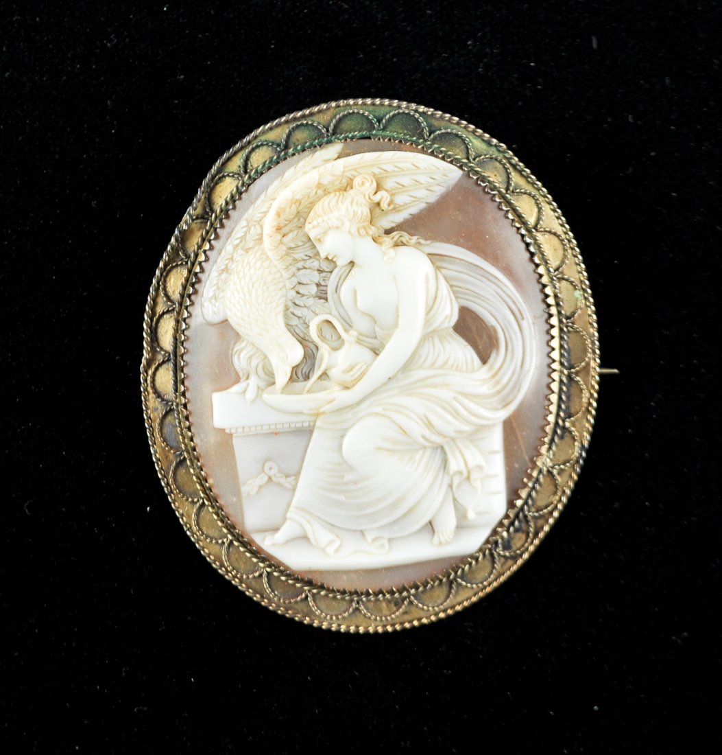 EARLY HEBE & EAGLE CARVED SHELL CAMEO: Carved shell cameo set in sterling silver. Dimensions: H 2.5" x W 2"Condition; Good, loosening of twisted edge in one area.