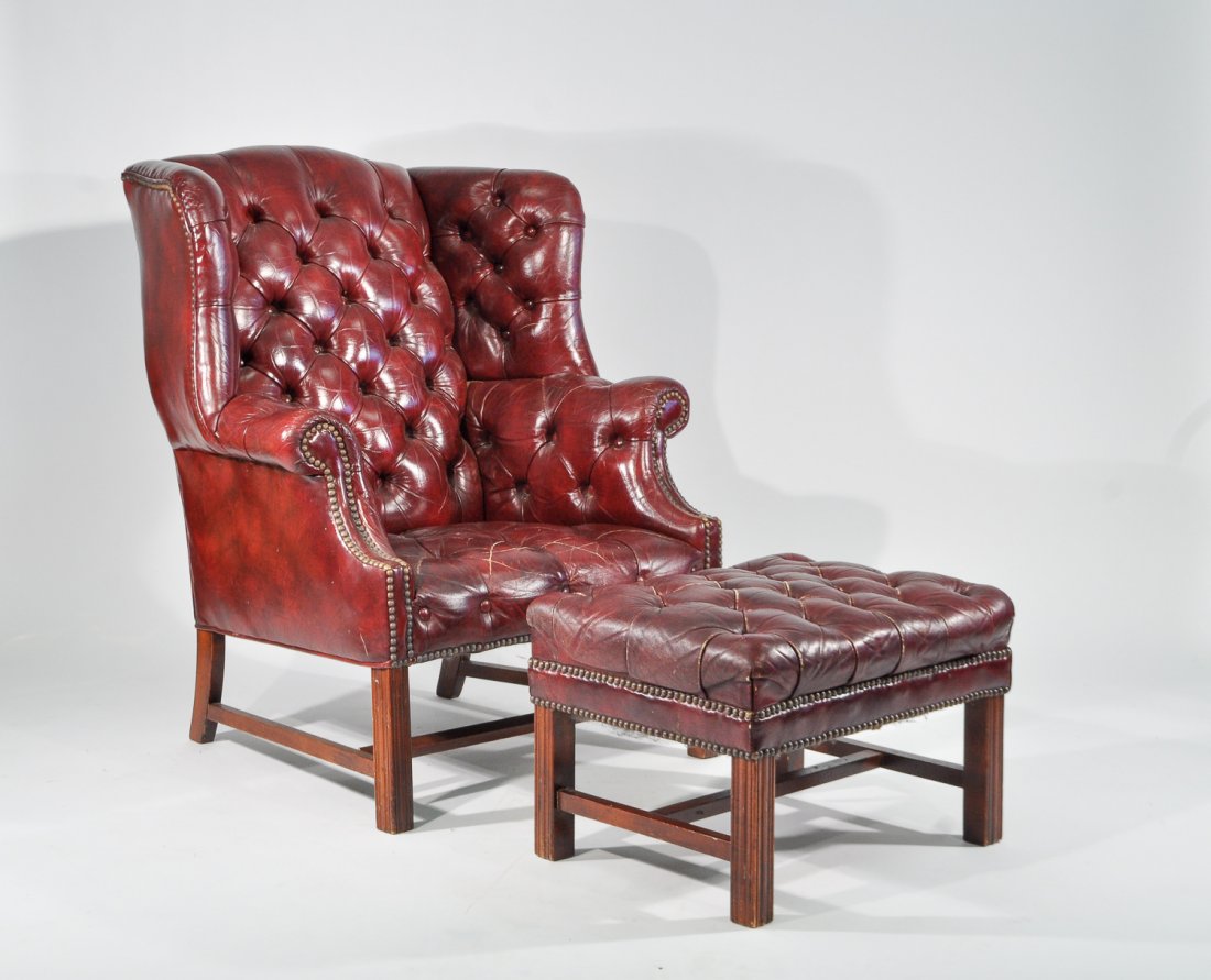 TUFTED WINGBACK CHAIR AND OTTOMAN: Vinyl Dimensions: H 42" x W 34" x D 34" Condition: vintage wear from use, some crackling to vinyl and wear around edges