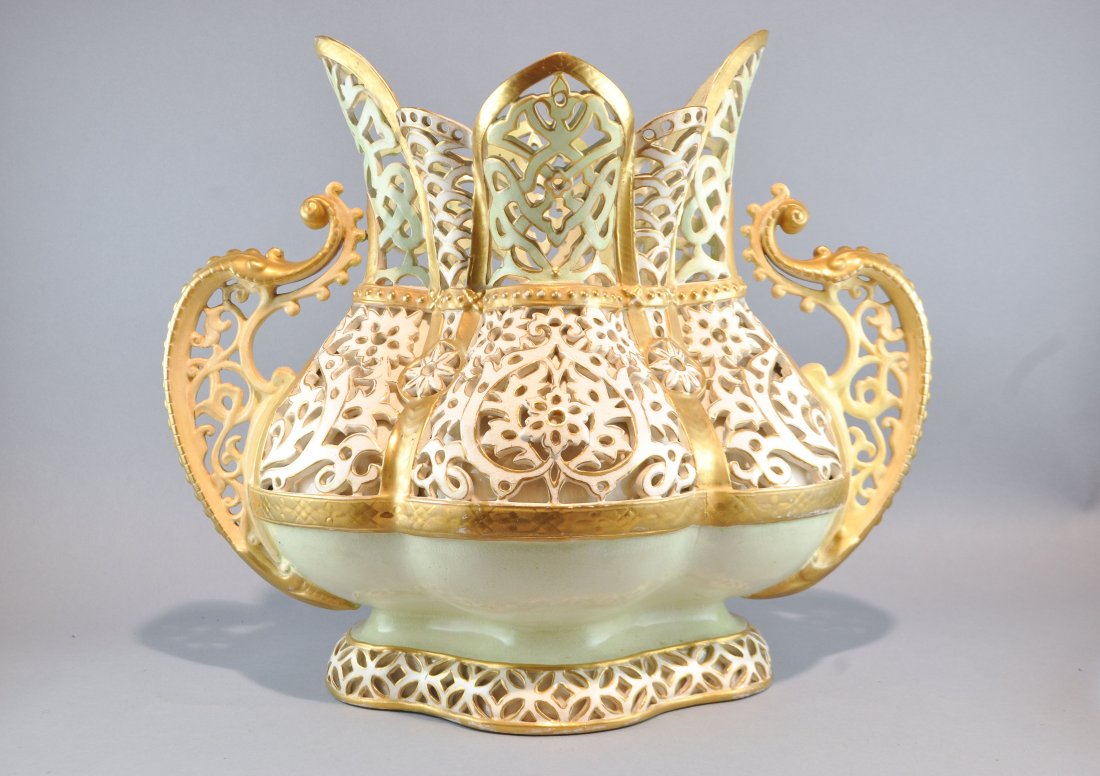 ZSOLNAY RETICULATED PORCELAIN CENTERPIECE: Unsigned with open lattice work decoration, gilt paint over a green and white glaze Dimensions: H 13.5" x W 16" x D 10"