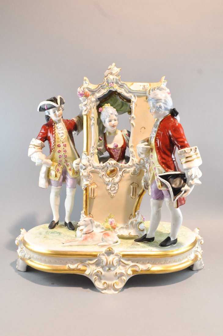 ROYAL DUX PORCELAIN GROUP: Two royal guards flanking a lady in a carriage, with foil label to bottom and mark beneath Dimensions: H 16" x W 15" x D 9"