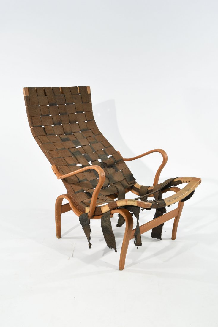 BRUNO MATHSSON 'PERNILLA' LOUNGE CHAIR: Birch laminated plywood, Karl Mathsson and Bruno Mathsson marks to frame Dimensions: H 36" x W 25" x D 38" Condition: as is, needs restoration to webbing, loss to a corner of one foot