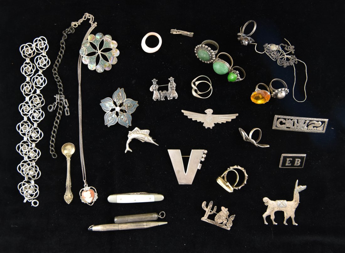 GROUPING OF STERLING JEWELRY: Including Mexican inlay brooches, pencils, rings etc. (knife and shell ring are not sterling) Dimensions: L 2" x W 2" Total Weight: 7.46 ozt Condition: Good, most wearable.