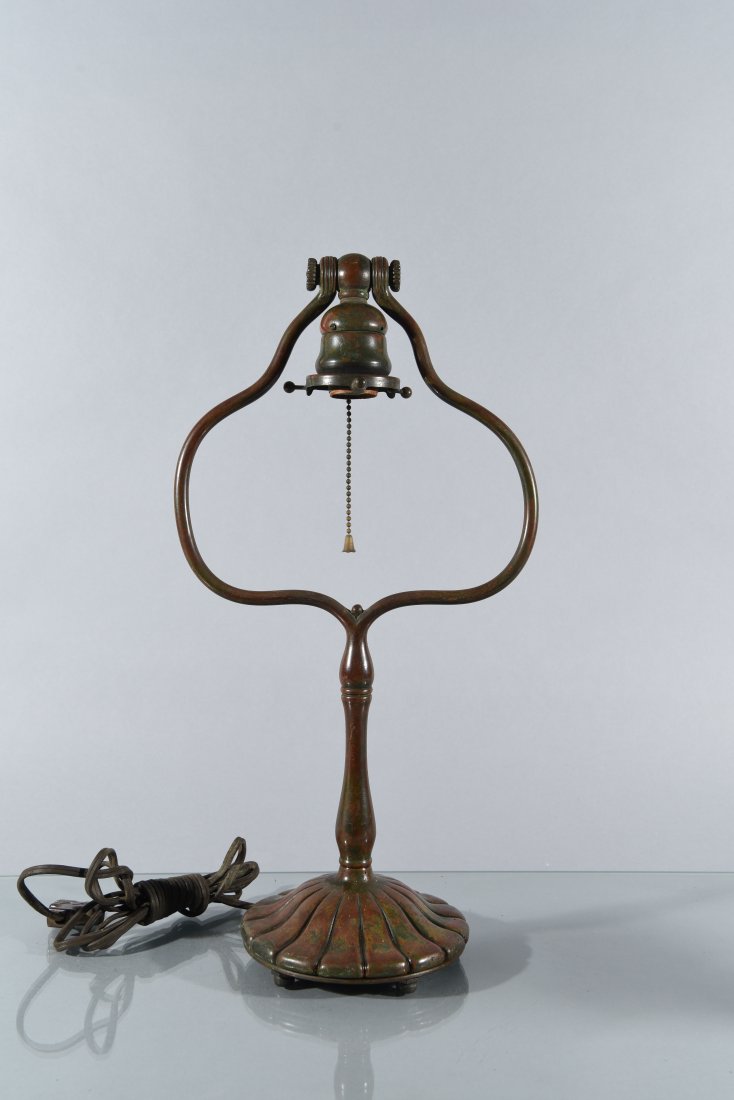 TIFFANY BRONZE DESK LAMP: Stamped on the bottom TIFFANY STUDIOS, NEW YORK 424. Dimensions: H17 7/8" x W9 1/4" x D5.5" Condition: As Found. Untested.