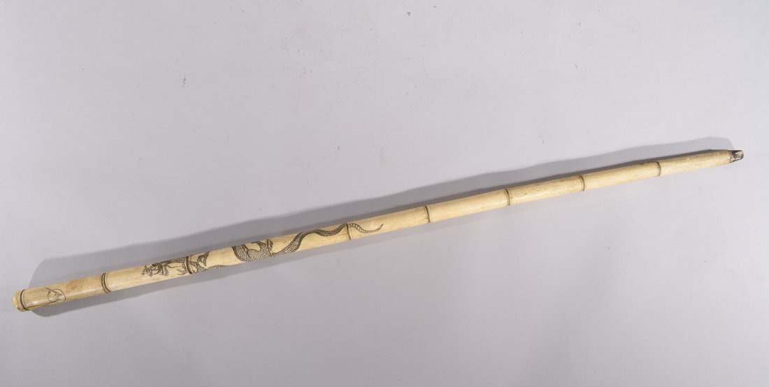 JAPANESE CARVED BONE SWORD C. 1880/90's: Carved dragon motife.Dimensions: H36.5"x D1" Condition: As Is. With losses and loose sections.