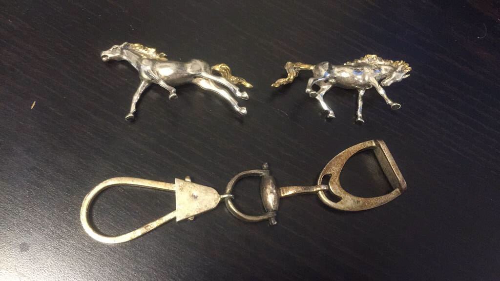 EQUESTRIAN STERLING SILVER GROUPING: Including horse bit key chain and two sterling silver and 10k gold figures. Dimensions: Key chain: L 5" x W 1" Weight: 3.1ozt Condition: Good, light scratching.