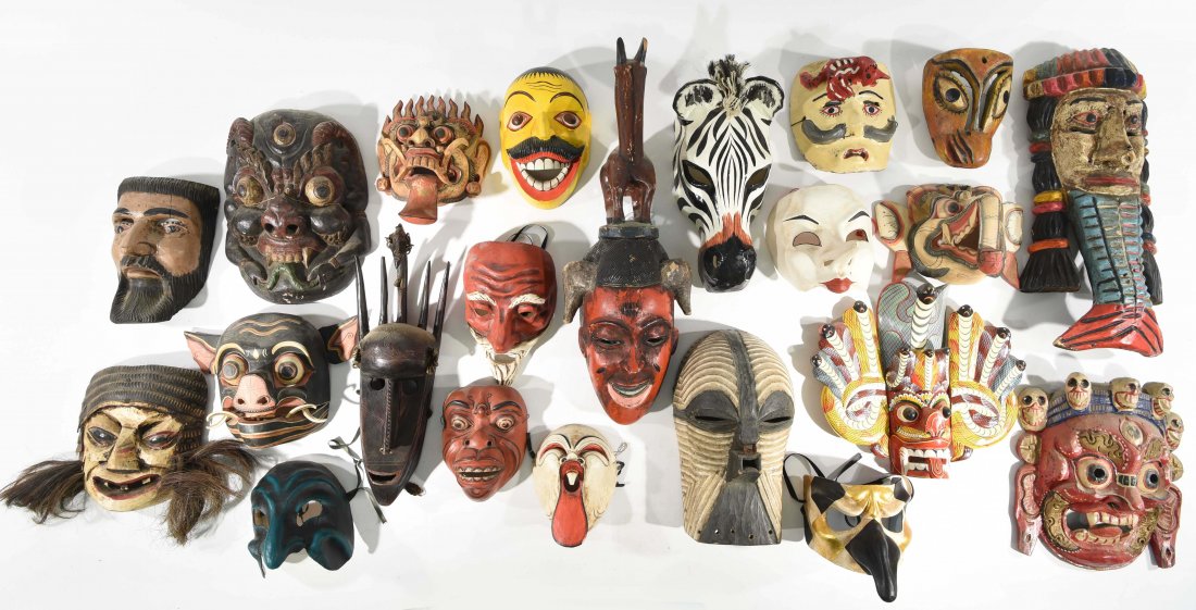 COLLECTION OF 20 MASKS.: A grouping of Indonesian, Mexican, African and Italian masks. Dimensions: H 25" x W 8" x D 7" (largest mask in center of photo.