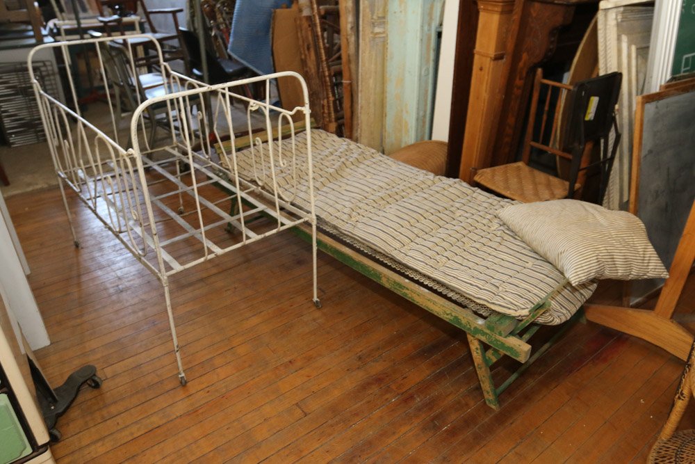 Wrought iron crib, and collapsible cabin cot: with a ticking mattress.